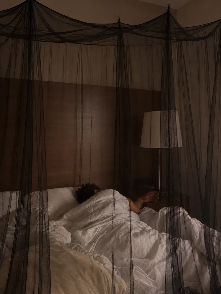 South African customer resting under a black canopy net